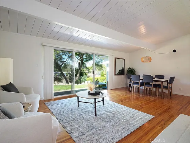 a living room with furniture and a coffee table with garden view