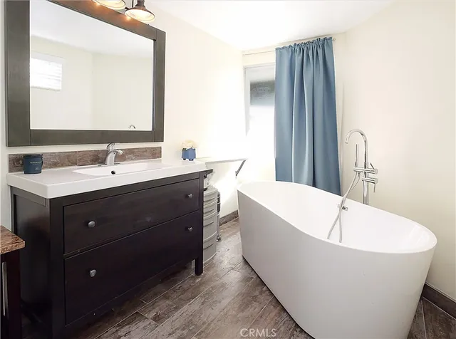 a bathroom with a bathtub and a sink