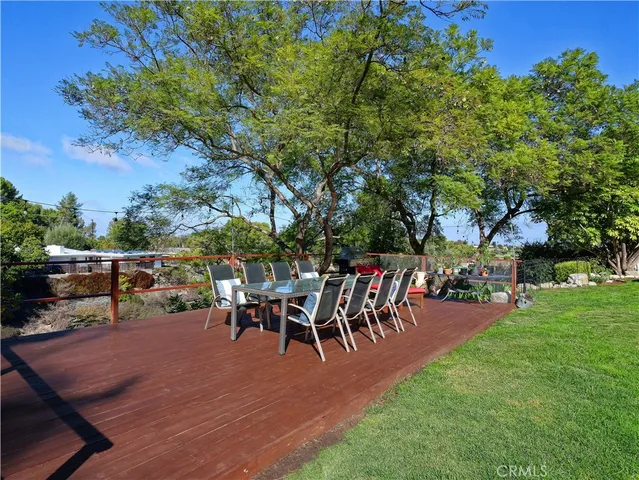 a view of a tables and chairs in patio and a yard