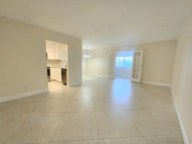 a view of a kitchen with a sink and a window