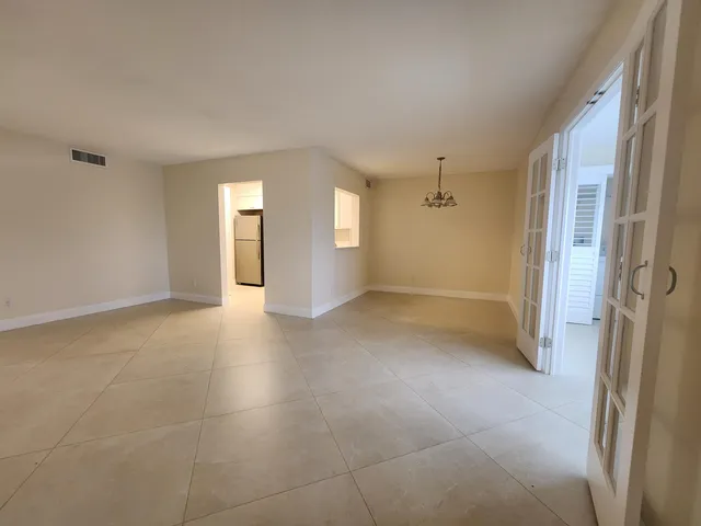 a view of a hallway with wooden floor and a window