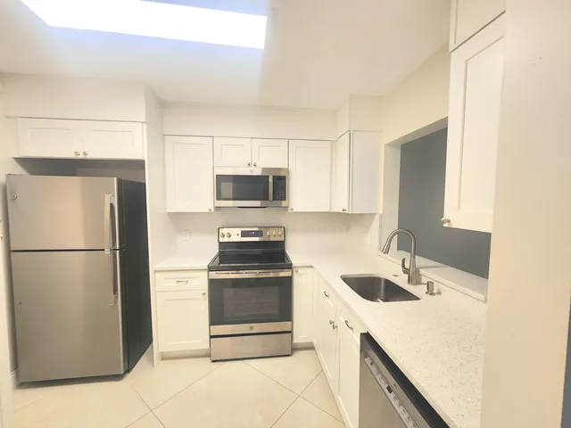 a kitchen with a refrigerator sink and stove