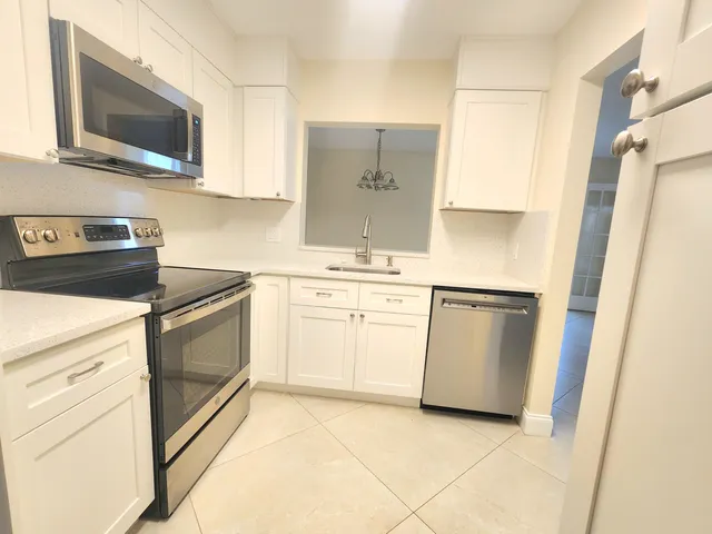 a kitchen with a stove microwave and sink
