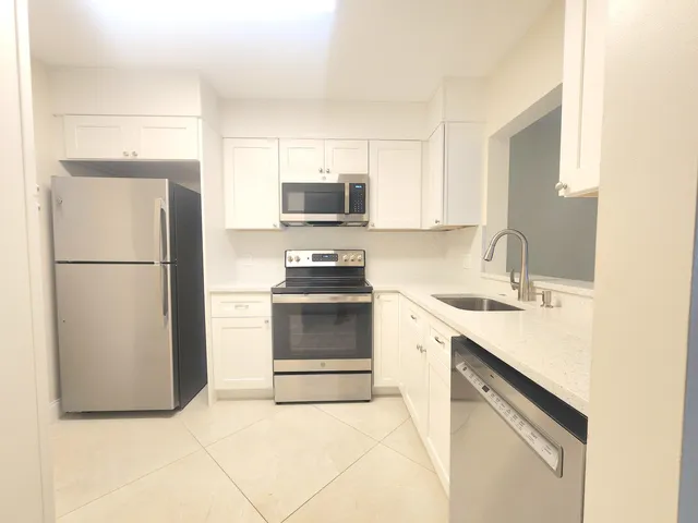 a kitchen with a refrigerator sink and microwave