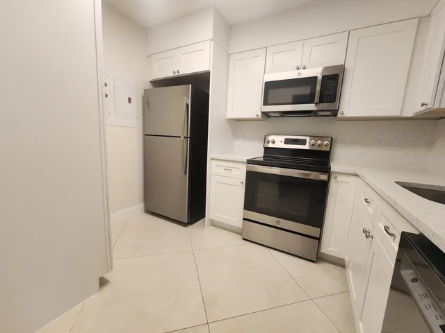 a kitchen with stainless steel appliances a refrigerator stove and microwave