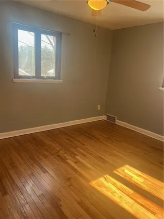 a view of a room with wooden floor