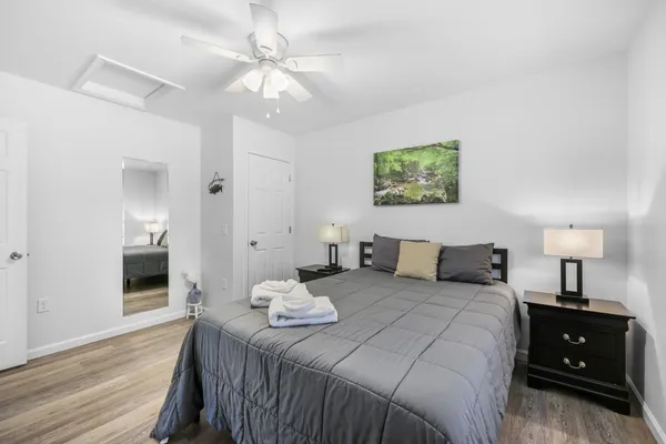 a bedroom with a bed and a chandelier