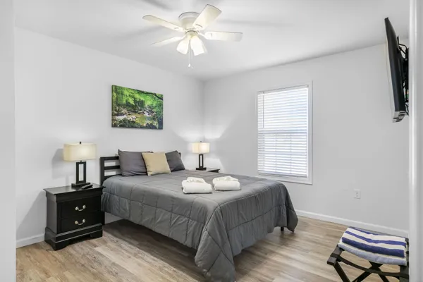 a bedroom with a bed and a chandelier