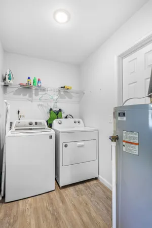 a utility room with cabinets washer and dryer