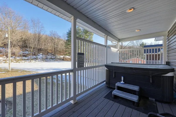 a view of a porch with wooden floor and outdoor seating