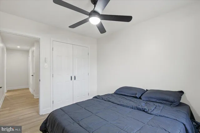 a bedroom with a bed and a ceiling fan