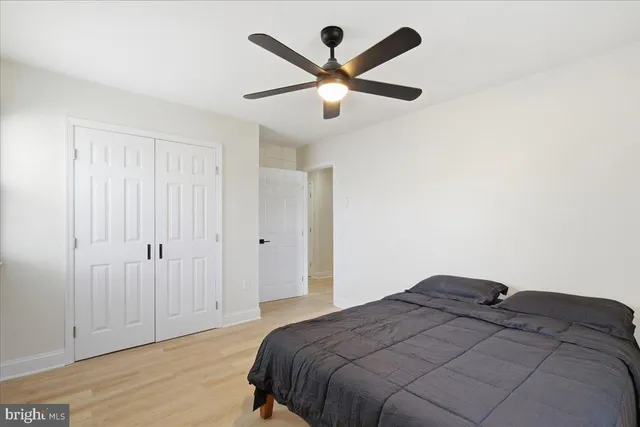 a bedroom with a bed and a ceiling fan