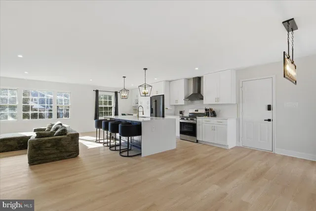 a kitchen with a refrigerator and a stove top oven