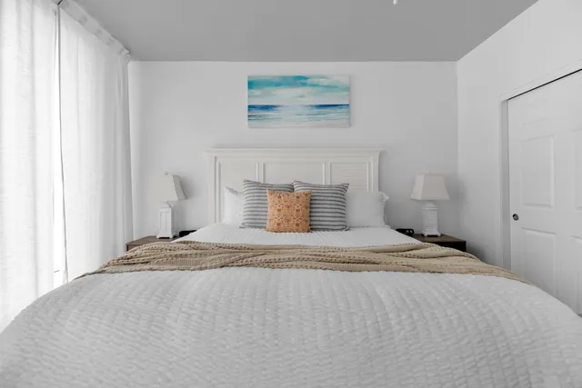 a bedroom with a bed and window