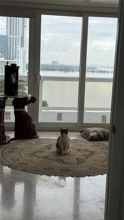 a room with granite countertop a couch and a window
