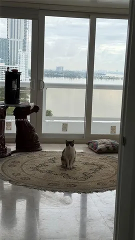 a room with granite countertop a couch and a window