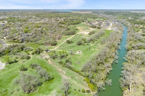 a view of a city with lush green forest