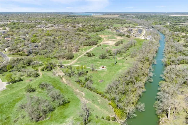 a view of a city with lush green forest