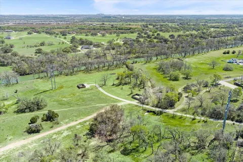 a view of outdoor space with green field and trees