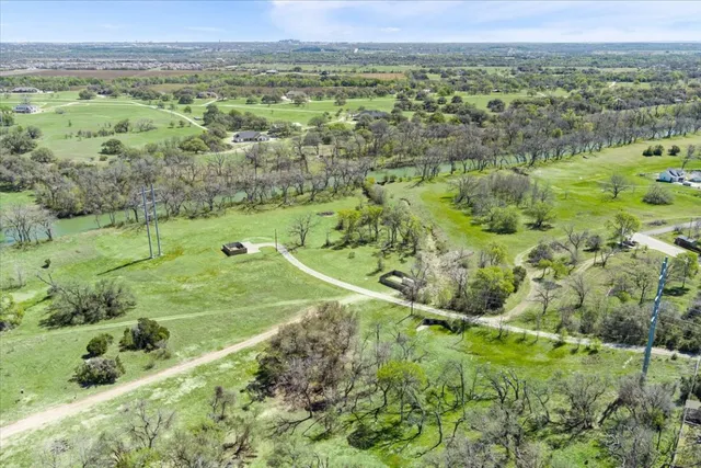 a view of outdoor space with green field and trees