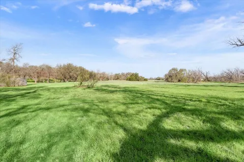 a backyard of apartments with large trees