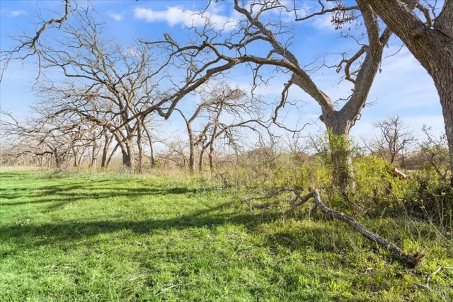 a view of a balcony with a yard