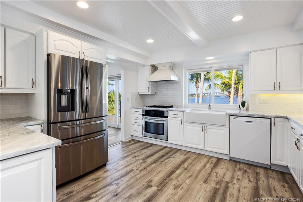 10 South Sewalls Point Road Stuart, FL 34996 - Photo 13 of 79 a kitchen with granite countertop stainless steel appliances a refrigerator sink and microwave