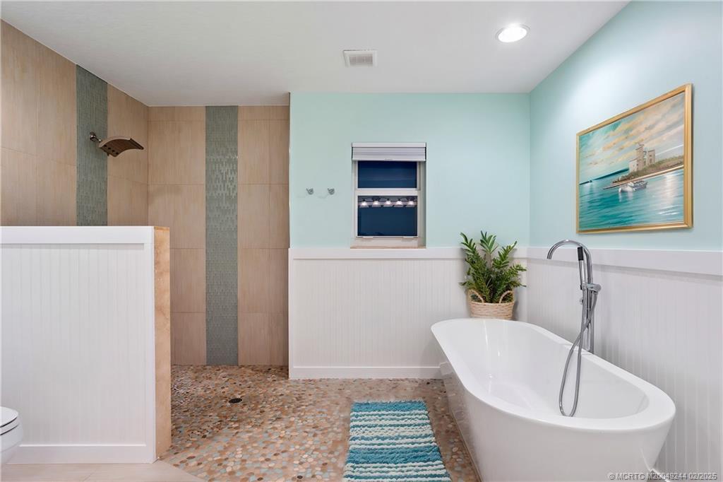 10 South Sewalls Point Road Stuart, FL 34996 - Photo 21 of 79 a white bath tub sitting in a bathroom