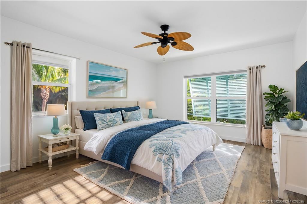 10 South Sewalls Point Road Stuart, FL 34996 - Photo 39 of 79 a spacious bedroom with a bed and a chandelier