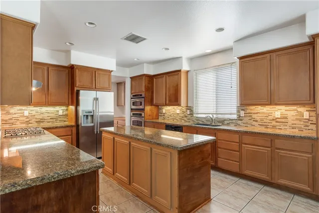 a kitchen with stainless steel appliances granite countertop a sink counter space cabinets and stainless steel appliances
