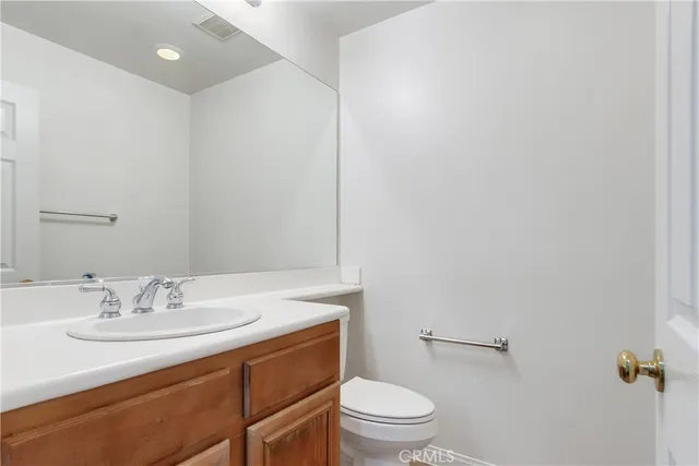 a bathroom with a sink toilet and a mirror