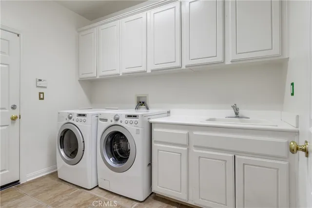 a utility room with sink dryer and washer