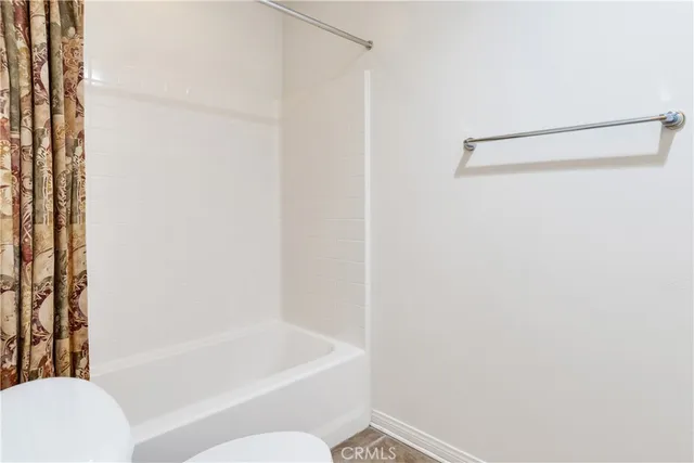 a bathroom with a bathtub and a toilet