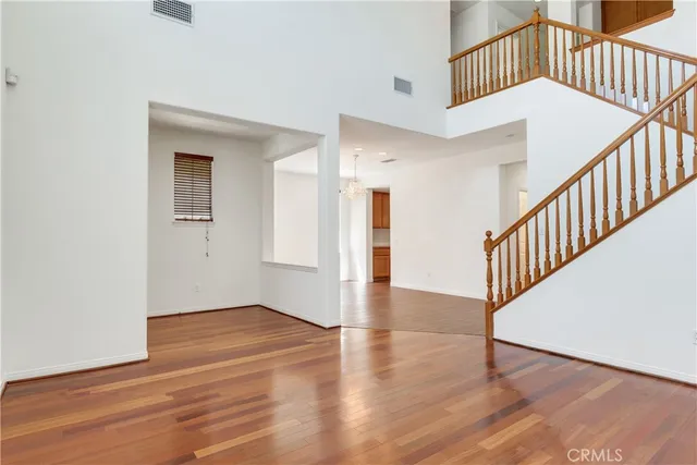 a view of staircase with white walls and wooden floor
