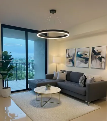 a living room with furniture and a large window