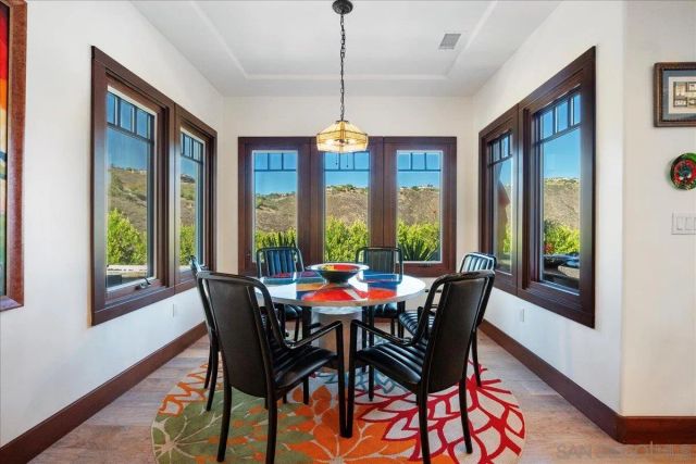a living room filled with furniture and a floor to ceiling window