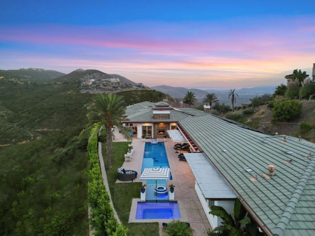 an aerial view of a house with mountain view