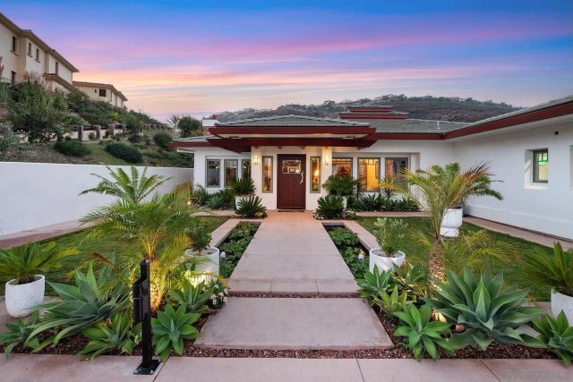 a kitchen with kitchen island granite countertop a sink and a stove