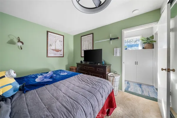a bedroom with bed and a chandelier