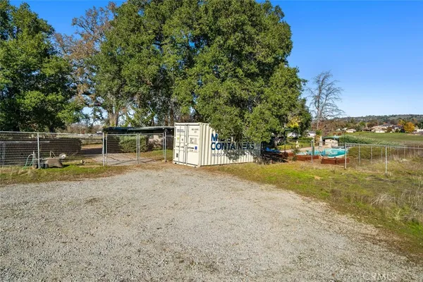 a view of a yard with a tree