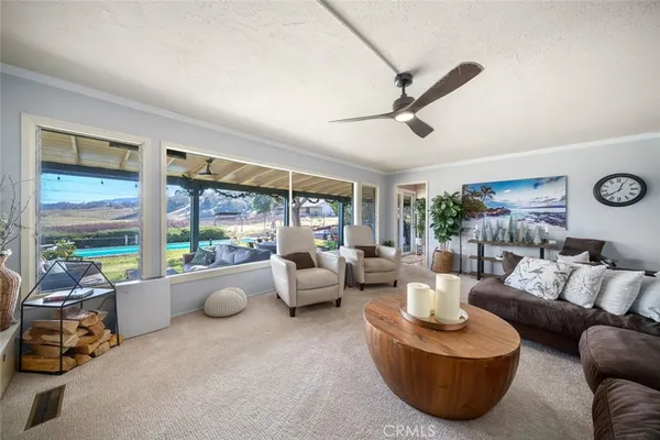 a kitchen with stainless steel appliances a stove top oven a sink dishwasher and white cabinets with wooden floor