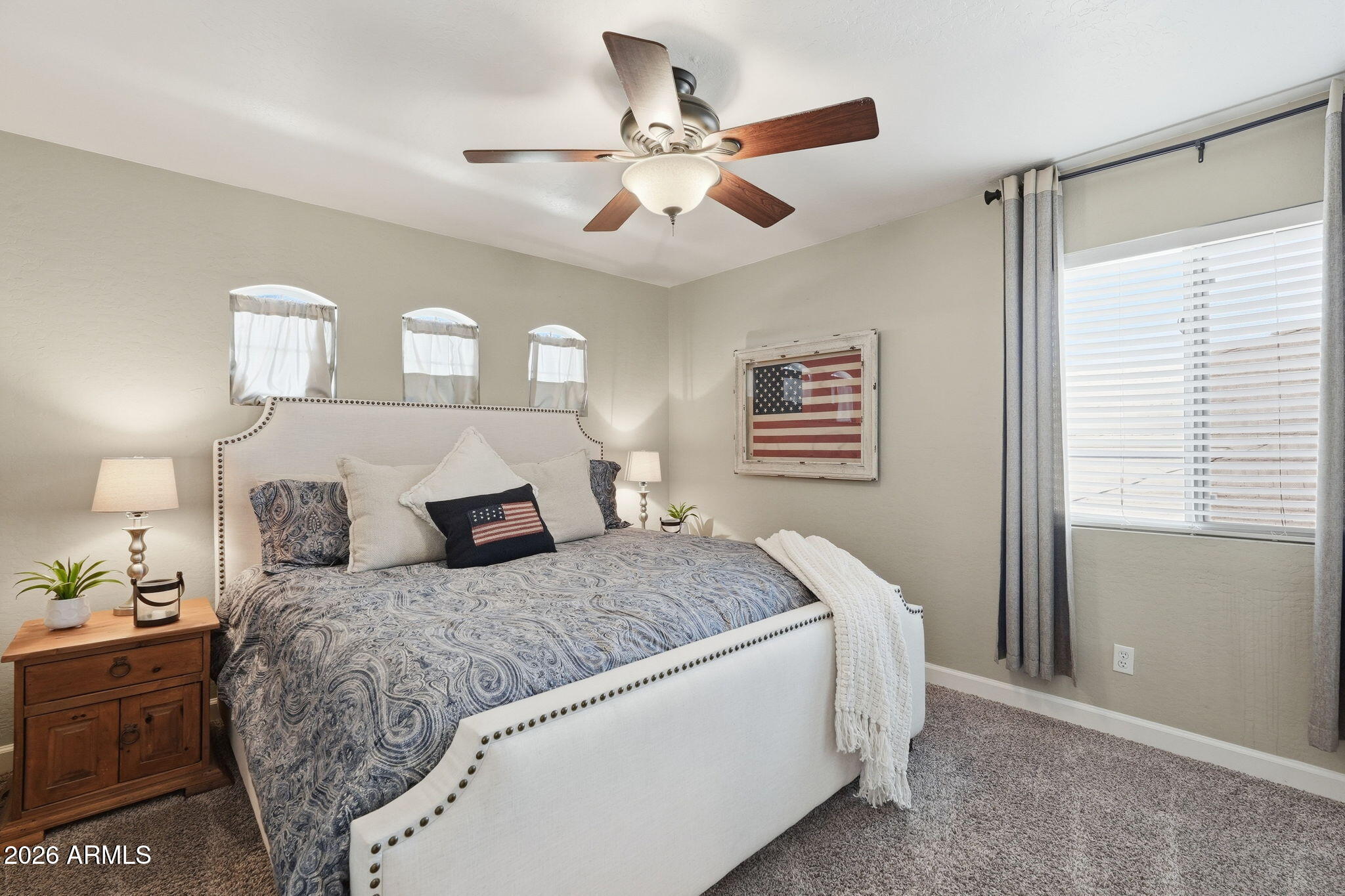 4021 East Kirkland Road Phoenix, AZ 85050 - Photo 21 of 35 a bedroom with a large bed and a chandelier