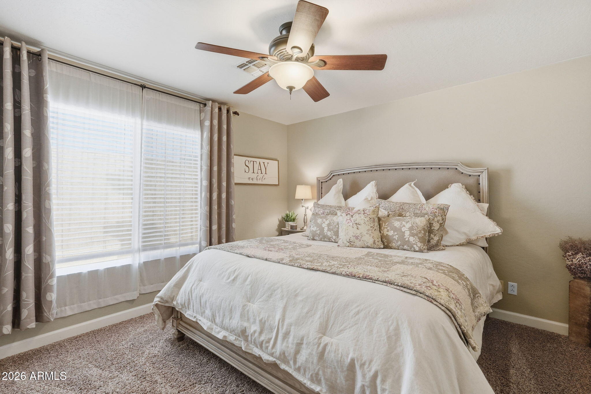 4021 East Kirkland Road Phoenix, AZ 85050 - Photo 22 of 35 a large bed sitting in a bedroom next to a window
