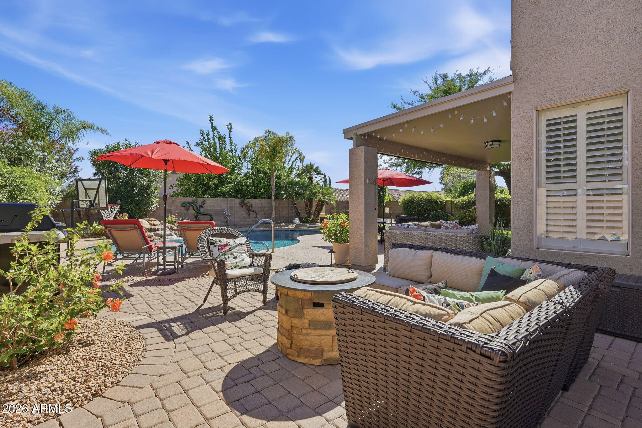 4021 East Kirkland Road Phoenix, AZ 85050 - Photo 26 of 35 a view of a patio with couches table and chairs under an umbrella with a fire pit