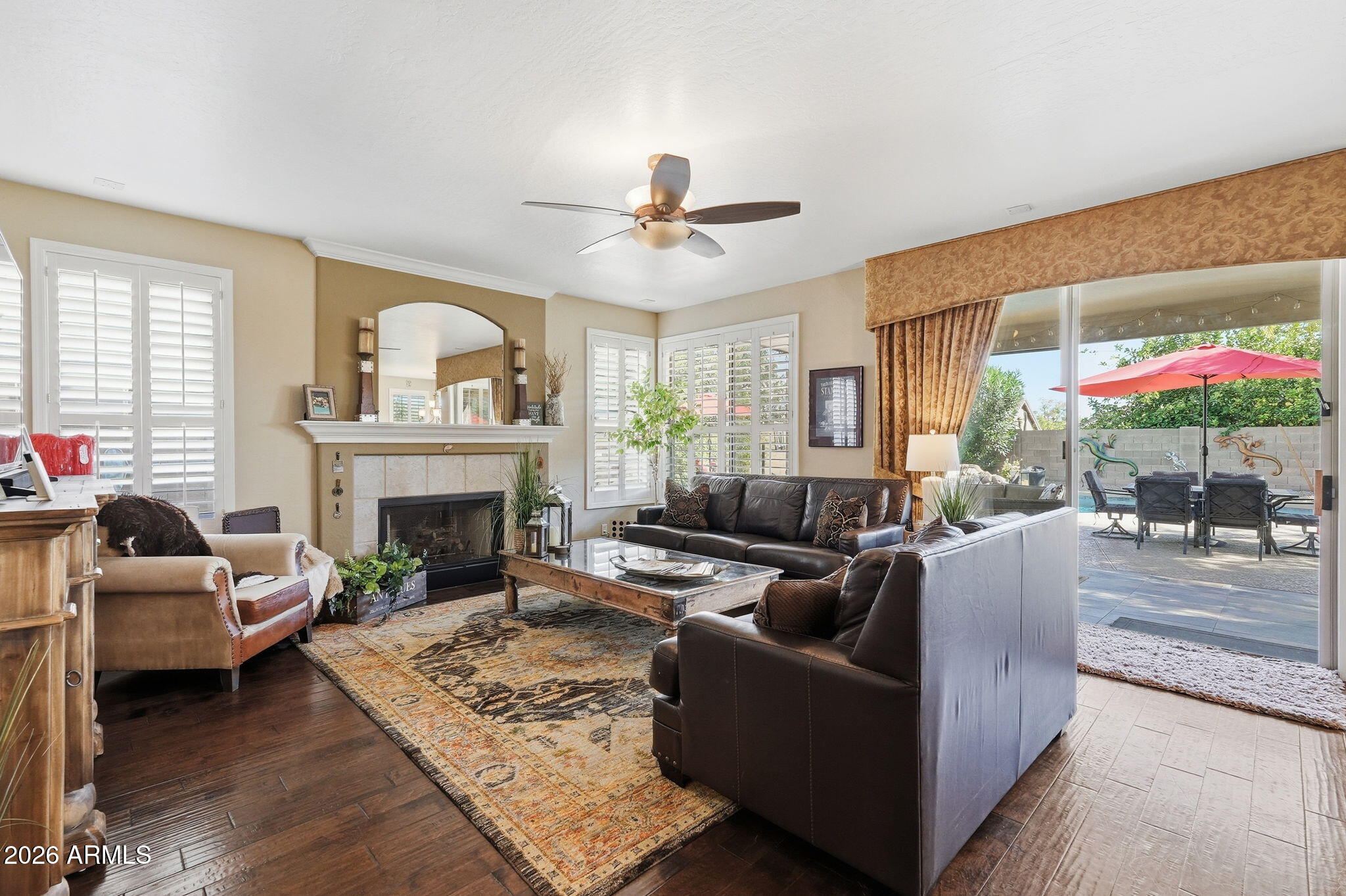 4021 East Kirkland Road Phoenix, AZ 85050 - Photo 5 of 35 a living room with furniture a fireplace and a large window