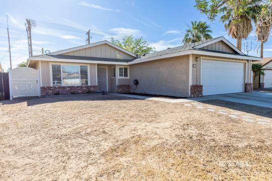 609 South Gemstone Street Ridgecrest, CA 93555 - Photo 3 of 35 a front view of a house with a yard and garage