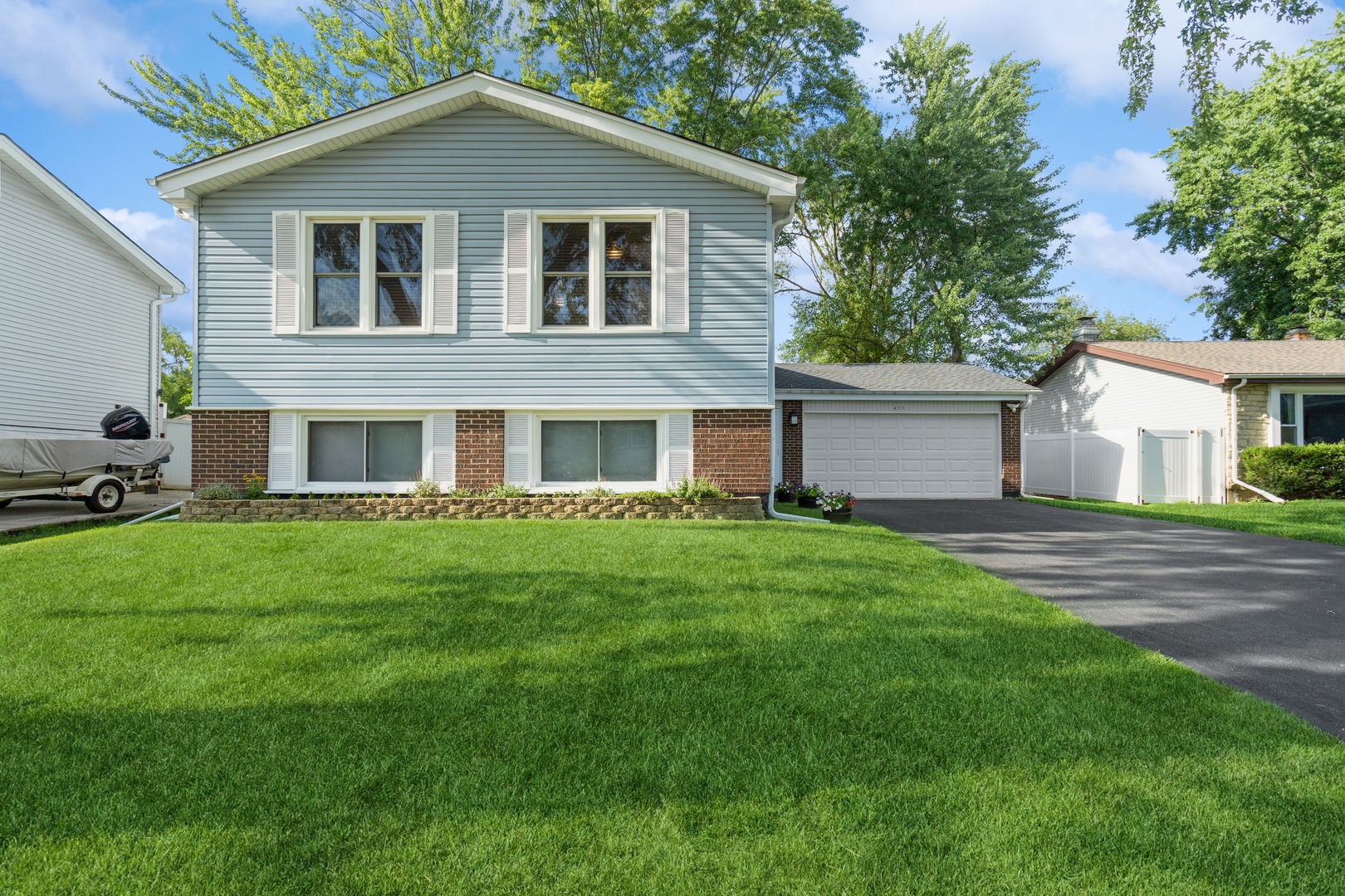 628 West Briarcliff Road Bolingbrook, IL 60440 - Photo 1 of 31 a front view of a house with a garden