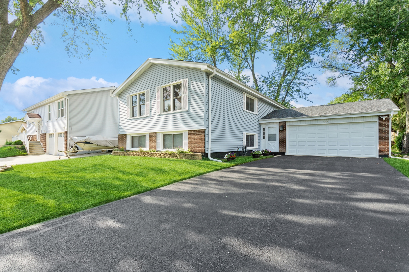628 West Briarcliff Road Bolingbrook, IL 60440 - Photo 2 of 31 a front view of a house with a yard and garage