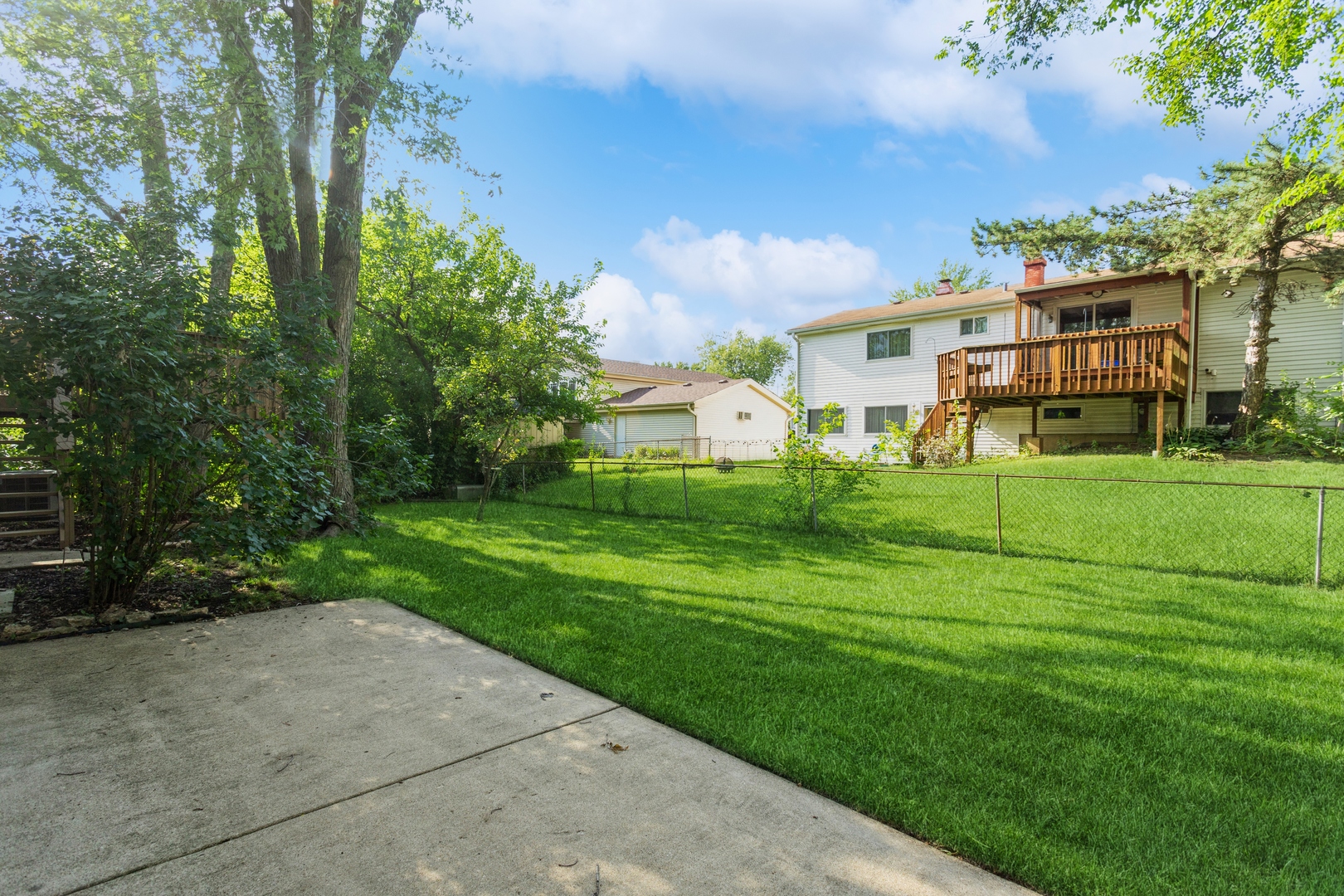 628 West Briarcliff Road Bolingbrook, IL 60440 - Photo 31 of 31 a view of a white house with a big yard and large trees