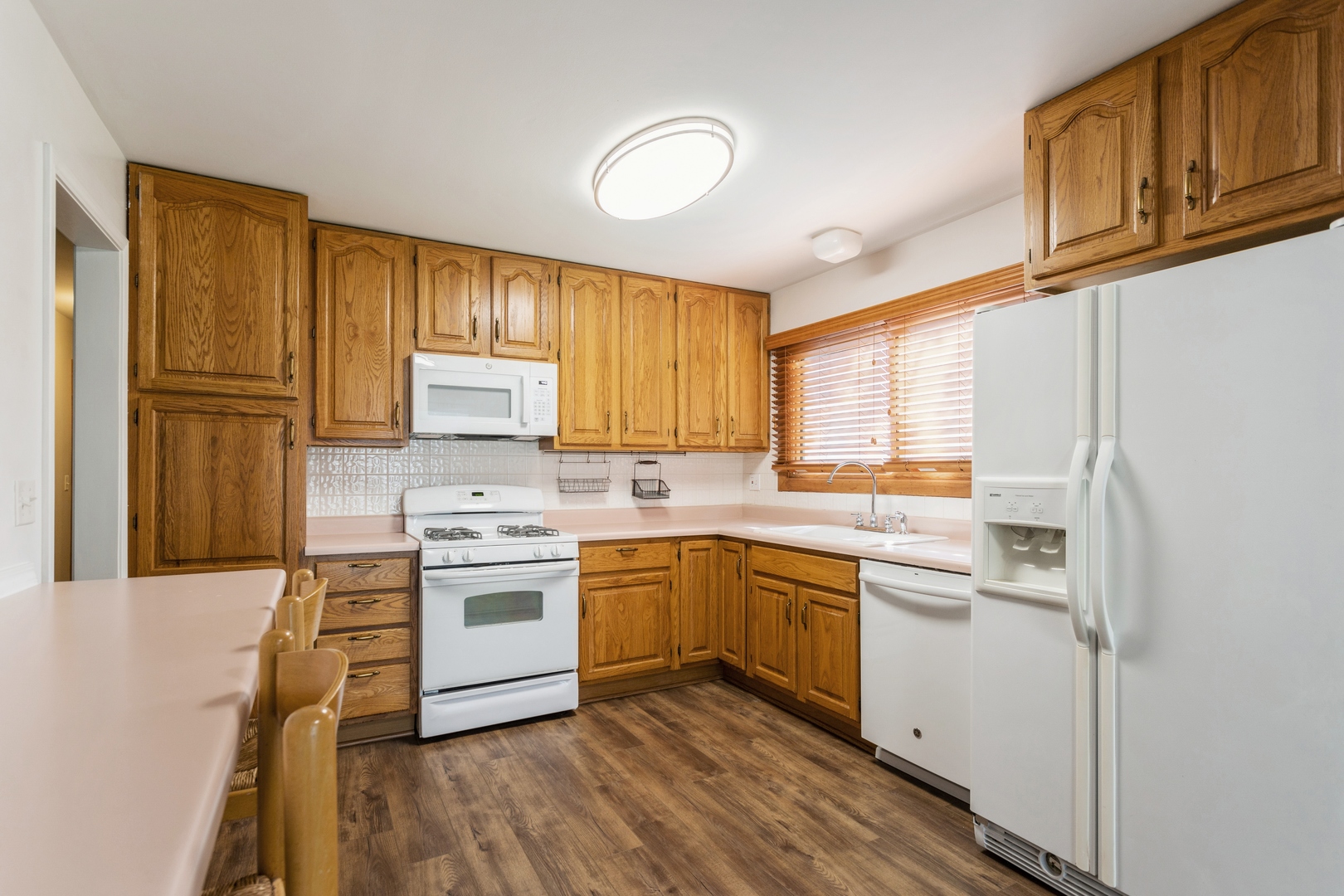 628 West Briarcliff Road Bolingbrook, IL 60440 - Photo 9 of 31 a kitchen with a sink cabinets appliances and a window